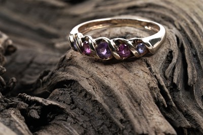 Lot 77 - A modern amethyst and tourmaline five-stone ring