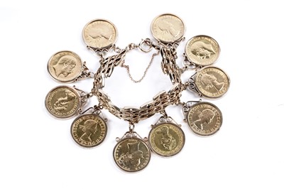 Lot 865 - A 9ct gold fancy-link bracelet set with ten gold sovereigns in fob mounts
