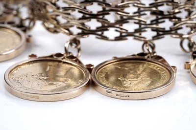 Lot 865 - A 9ct gold fancy-link bracelet set with ten gold sovereigns in fob mounts