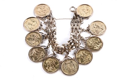 Lot 865 - A 9ct gold fancy-link bracelet set with ten gold sovereigns in fob mounts