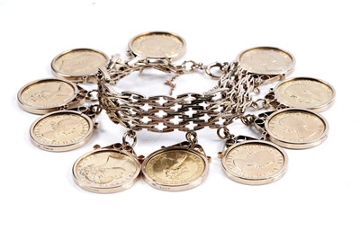 Lot 865 - A 9ct gold fancy-link bracelet set with ten gold sovereigns in fob mounts