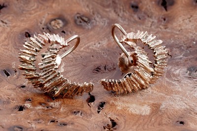 Lot 62 - A pair of 1970's bark effect 9ct gold earrings