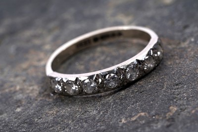 Lot 51 - A 1970s diamond half hoop eternity ring