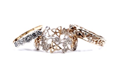 Lot 50 - Three diamond set rings, including: an Arts and Crafts style band
