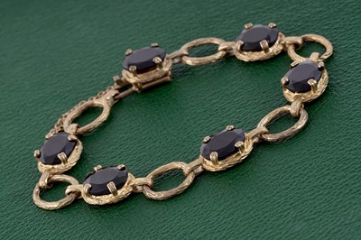 Lot 54 - A 1970's garnet bracelet, on 9ct gold