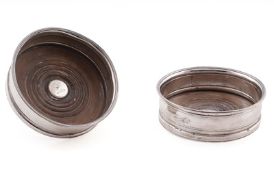 Lot 183 - A pair of George III silver wine coasters