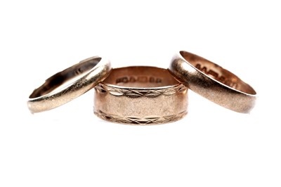 Lot 189 - Two 9ct yellow gold wedding bands; and another ring