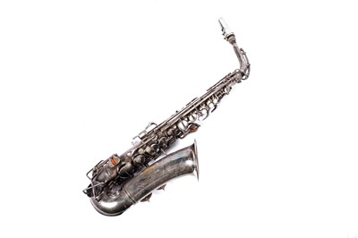 Lot 35 - A Buescher Aristocrat Low Pitch alto saxophone; and a painted plywood music bandstand