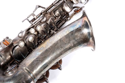 Lot 35 - A Buescher Aristocrat Low Pitch alto saxophone; and a painted plywood music bandstand