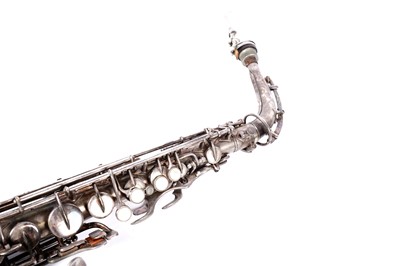 Lot 35 - A Buescher Aristocrat Low Pitch alto saxophone; and a painted plywood music bandstand