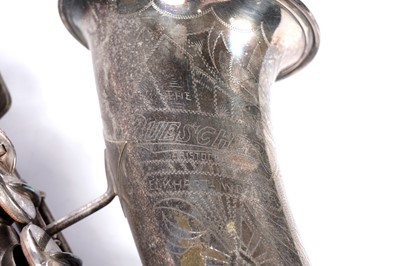 Lot 35 - A Buescher Aristocrat Low Pitch alto saxophone; and a painted plywood music bandstand