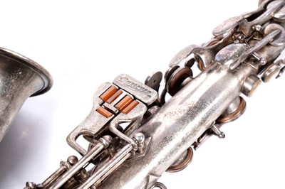 Lot 35 - A Buescher Aristocrat Low Pitch alto saxophone; and a painted plywood music bandstand