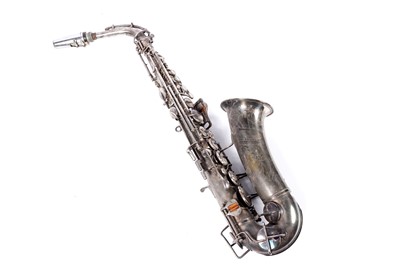 Lot 35 - A Buescher Aristocrat Low Pitch alto saxophone; and a painted plywood music bandstand