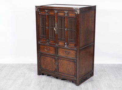 Lot 21 - An Oriental brass mounted cabinet