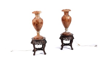 Lot 498 - A pair of early 20th Century Alabaster urns; and a pair of carved hardwood Chinese lamp stands
