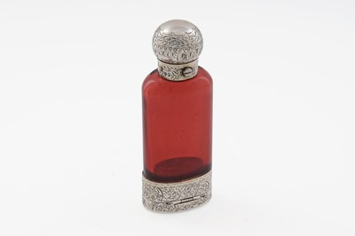 Lot 702 - A Victorian silver-gilt mounted ruby coloured glass scent bottle and vinaigrette combined