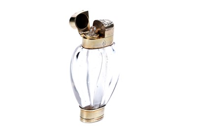 Lot 704 - A Victorian silver-gilt mounted clear glass scent bottle