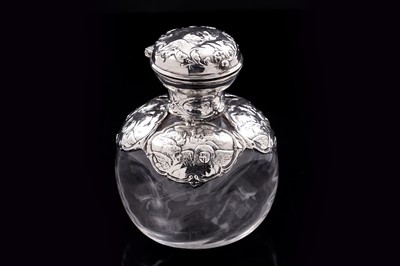 Lot 743 - An Edwardian art noveau silver mounted clear glass toilet water bottle