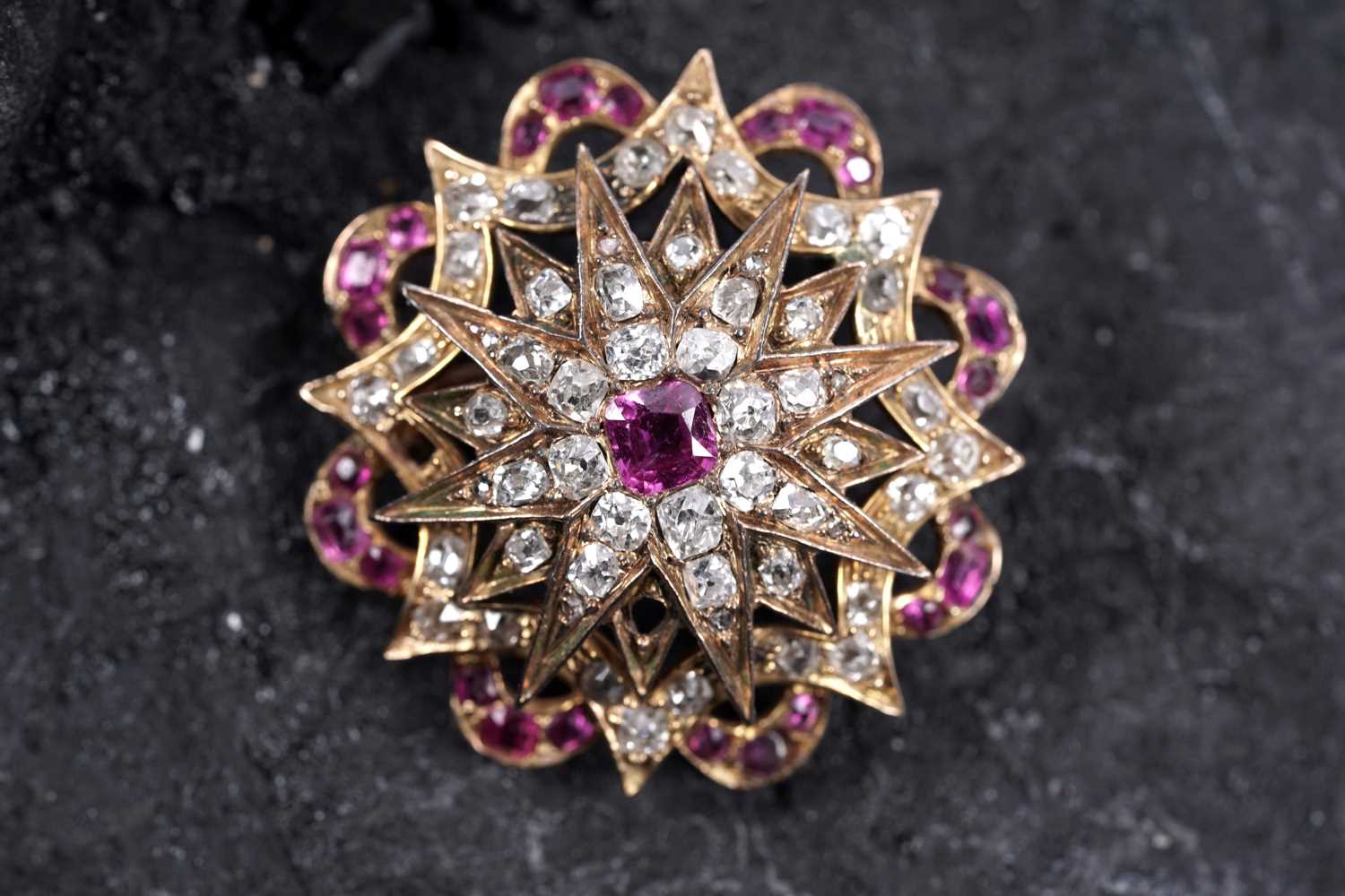 Lot 979 - A Victorian ruby and diamond star pattern brooch