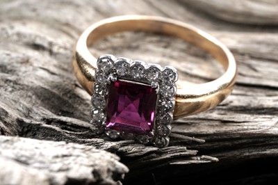 Lot 828 - A ruby and diamond cluster ring