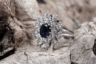 Lot 888 - A sapphire and diamond cluster ring