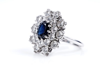 Lot 888 - A sapphire and diamond cluster ring
