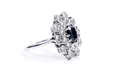 Lot 888 - A sapphire and diamond cluster ring