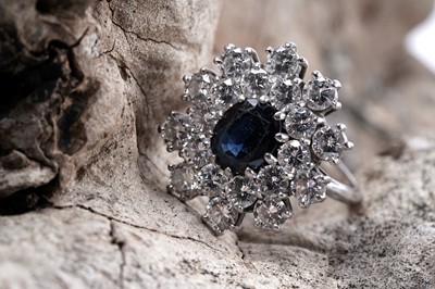 Lot 888 - A sapphire and diamond cluster ring
