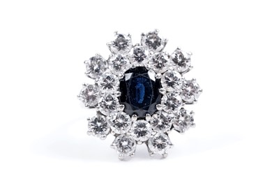 Lot 888 - A sapphire and diamond cluster ring
