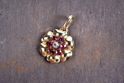 Lot 248 - A ruby and diamond flowerhead pattern pendant