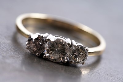Lot 858 - A three stone diamond ring