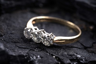 Lot 859 - A three stone diamond ring