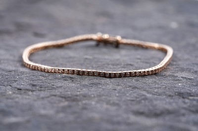Lot 960 - A diamond tennis bracelet
