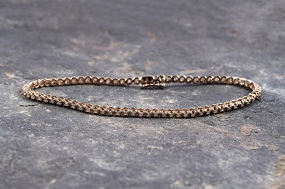 Lot 961 - A diamond tennis bracelet