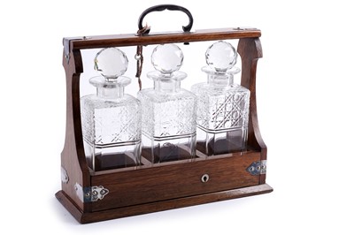 Lot 200 - An Edwardian oak three bottle tantalus
