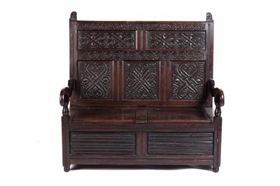 Lot 581 - An early 20th Century oak box settle