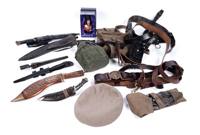 Lot 545 - Bladed weapons including four kukris; and other military items