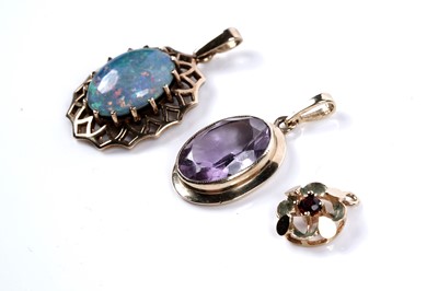 Lot 511 - A synthetic Gilson opal pendant; an amethyst pendant; and a garnet pendant