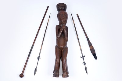 Lot 315 - An African carved hardwood figure; and four spears