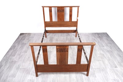 Lot 54 - An early 20th Century carved oak Arts & Crafts Liberty style bedframe