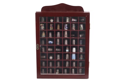 Lot 520 - A collection of silver and other thimbles in a display case