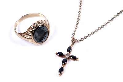 Lot 318 - A hematite intaglio signet ring; and a sapphire and diamond cruciform pendant