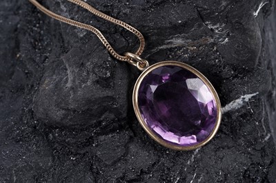 Lot 321 - An early 20th Century oval mixed-cut amethyst pendant