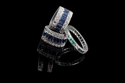 Lot 226 - An early 20th Century emerald and white sapphire eternity ring; and paste ear clips