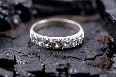 Lot 277 - A contemporary white spinel half hoop eternity ring