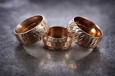 Lot 281 - Three 9ct gold wedding bands with engraved decoration