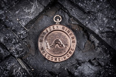 Lot 294 - A 9ct rose gold Great War interest fob medallion "Marsden Miners Welcome Home"