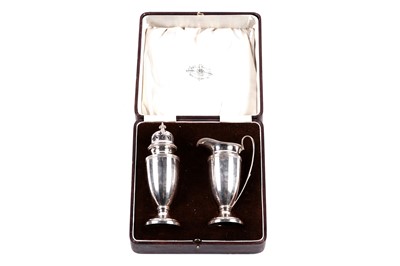 Lot 515 - A cased George V silver strawberry set retailed by Reid and Sons