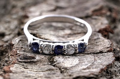 Lot 138 - A contemporary sapphire and diamond half hoop eternity ring