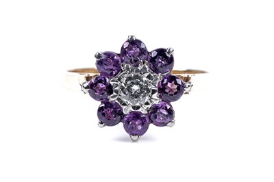 Lot 142 - An amethyst and diamond flowerhead pattern ring